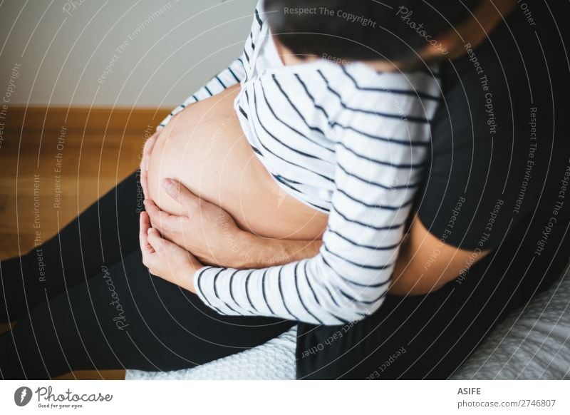 Pregnant couple hugging and touching womans belly Happy Beautiful Body Baby Woman Adults Man Parents Mother Father Family & Relations Couple Touch Smiling Love