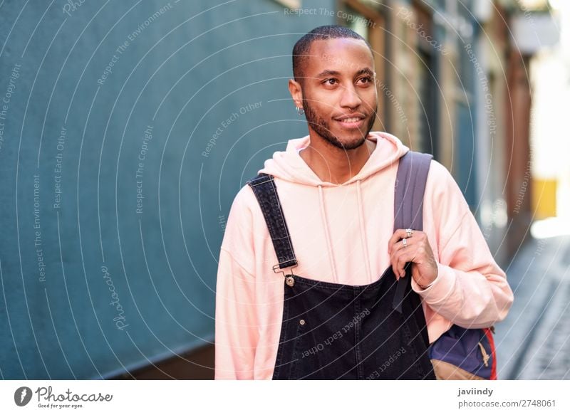 Young black man wearing casual clothes walking smiling down the street Lifestyle Happy Beautiful Human being Man Adults Street Fashion Clothing Shirt Sweater