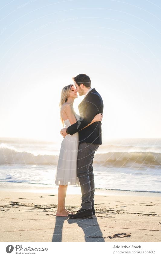 Tender kissing bridal couple in sunlight Couple Wedding Beach Sunlight embracing Engagement Contentment valentine enjoyment in love seascape Stand Relationship