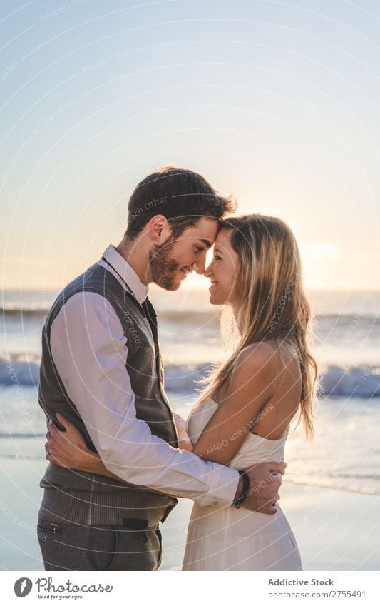 Tender kissing bridal couple in sunlight Couple Wedding Beach Sunlight embracing Engagement Contentment valentine enjoyment in love seascape Stand Relationship