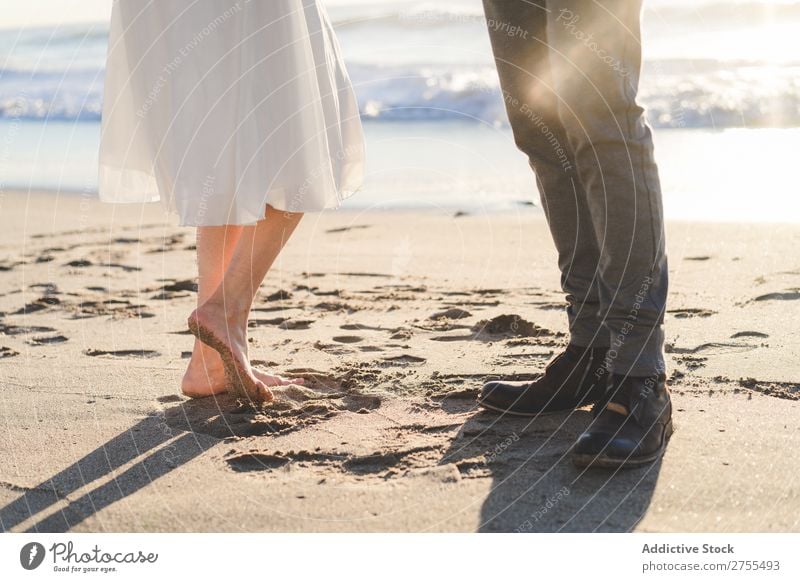 Crop bride and groom on sand Couple Groom Bride Sand Beach Stand Feet in love newlyweds Nature Coast Sunlight Relationship Beauty Photography Barefoot