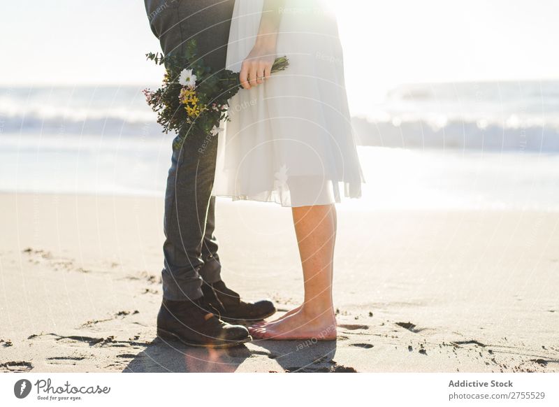 Crop bride with bouquet embracing groom Couple bridal Embrace Bouquet Feasts & Celebrations Wedding Nature romantic Beach Traveling Love Rustic Flower Together