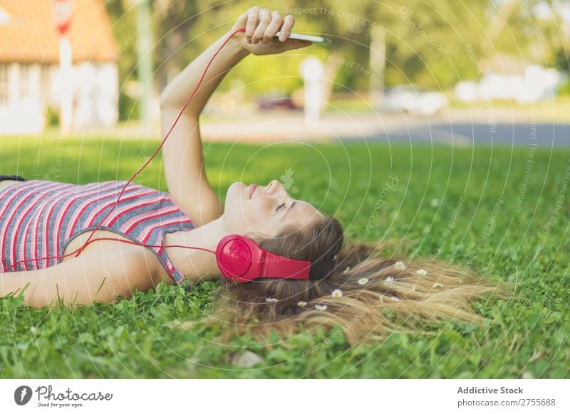 Girl with gadgets on lawn Woman Headphones Relaxation PDA Feminine Music Dream Flower Meadow Entertainment Student Park Summer Freedom Contentment Nature