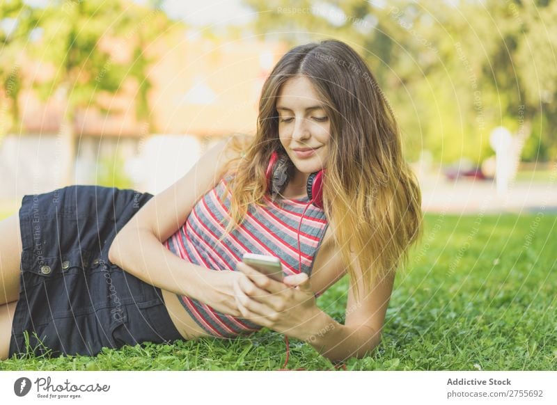 Girl with gadgets on lawn Woman Headphones Relaxation PDA Feminine Music Dream Flower Meadow Entertainment Student Park Summer Freedom Contentment Nature