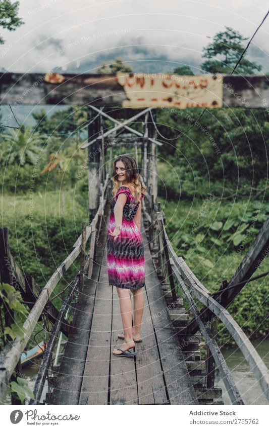 Pretty woman on wooden bridge Woman pretty Posture Nature Wood grungy Bridge Green Sunbeam Day Beautiful Beauty Photography Natural Youth (Young adults)