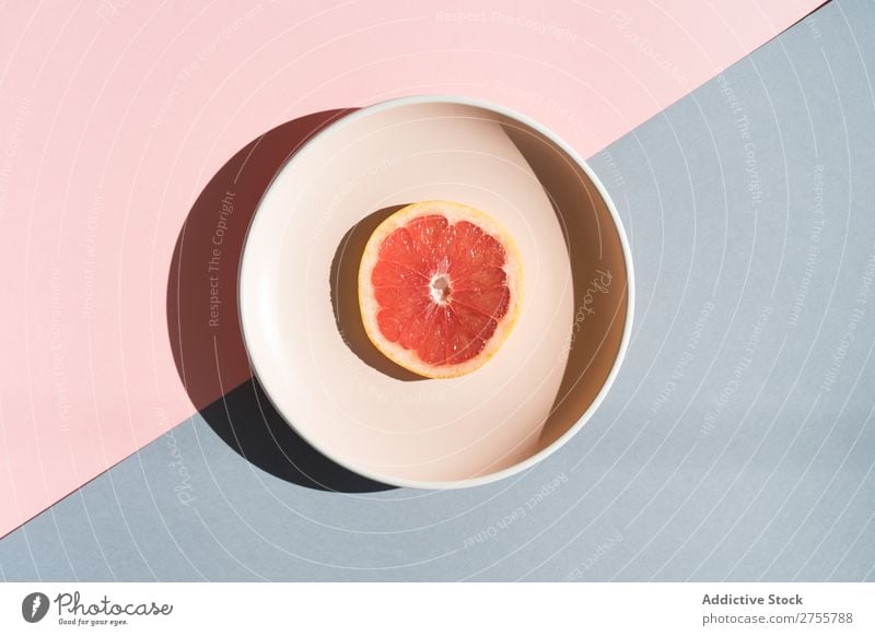 Grapefruit half on round plate Arrangement Plate Colour Studio shot Symmetry geometric Slice Exotic Sweet composition Healthy minimalist Fresh Dessert Bright