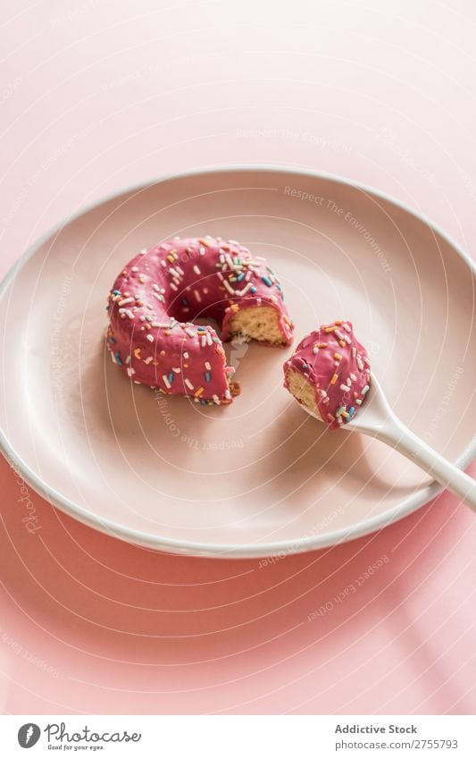 Sweet pink doughnut on plate Donut Pink Bite Studio shot Delicious Dessert Art Piece Candy Gourmet Nutrition Creativity Eating Spoon Fresh Baked goods