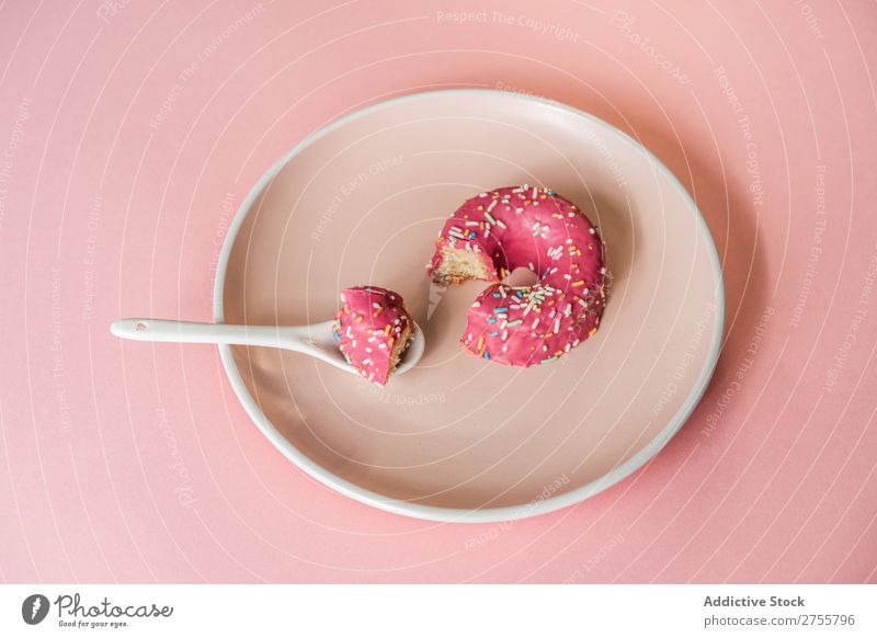 Sweet pink doughnut on plate Donut Pink Bite Studio shot Delicious Dessert Art Piece Candy Gourmet Nutrition Creativity Eating Spoon Fresh Baked goods