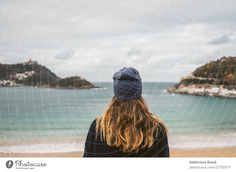 Attractive woman standing at ocean Woman Youth (Young adults) Coast Ocean pretty Hat Looking back at camera Nature Water Vacation & Travel Beach San Sebastián