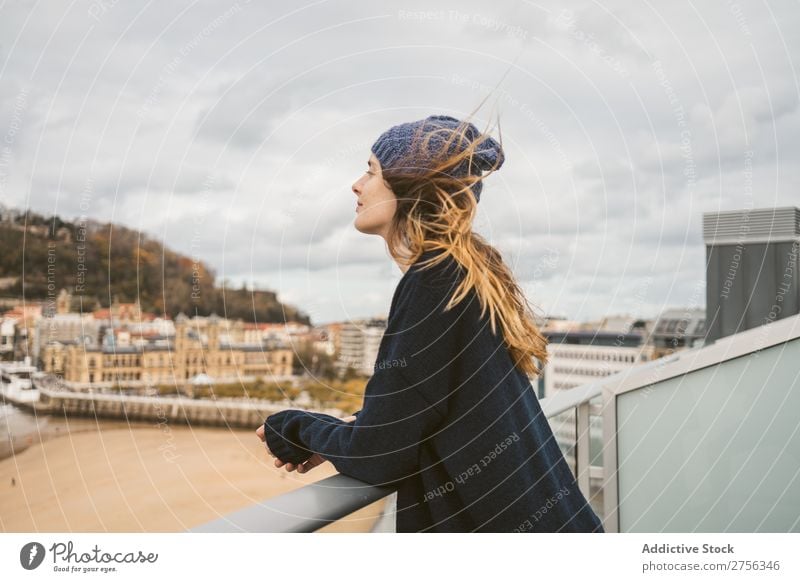 Woman at handrail at seaside Youth (Young adults) Coast Ocean Looking away Stand Lean Handrail pretty Attractive Hat Nature Water Vacation & Travel Beach