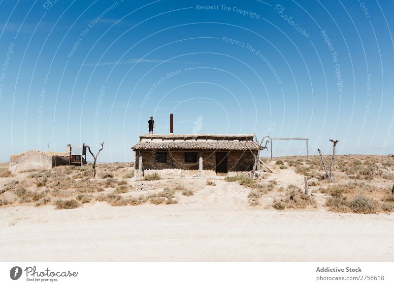 Man standing on hut roof Hut Roof Desert Vacation & Travel Lifestyle Human being Adults Nature Adventure Trip Tourist Landscape House (Residential Structure)