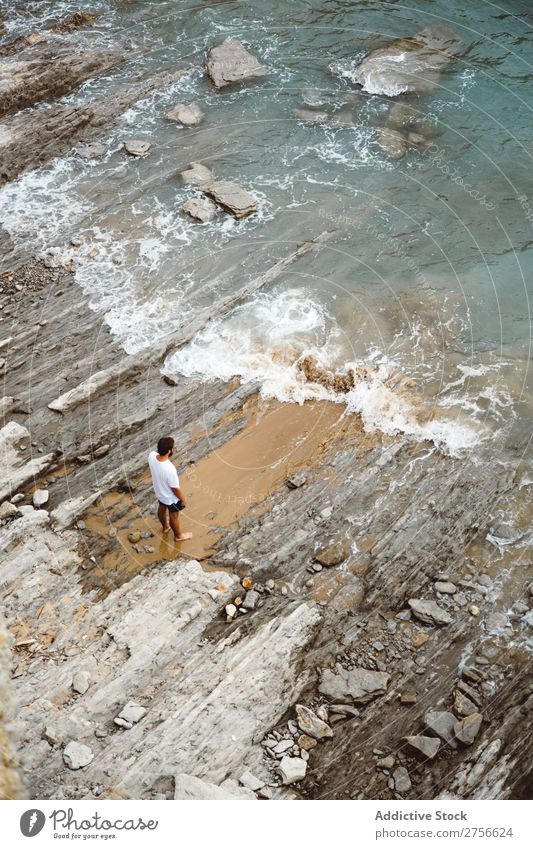 Man standing on rocky beach Tourist Cliff Ocean Rock Vacation & Travel Tourism Nature Landscape Coast Water Sun Freedom Stone Natural Lifestyle Beautiful