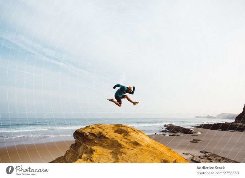 Man jumping on cliff Tourist Cliff Rock Vacation & Travel Tourism Nature Landscape Sit Rest Sun Freedom Stone Natural Lifestyle Beautiful Looking away