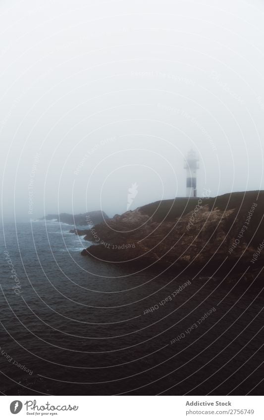 Lighthouse on rocky coastline Ocean Cape Nature Sky Rock Stone Coast Bay Vantage point Beautiful Beacon Building Storm Foam Fog guiding Picturesque tumultuous