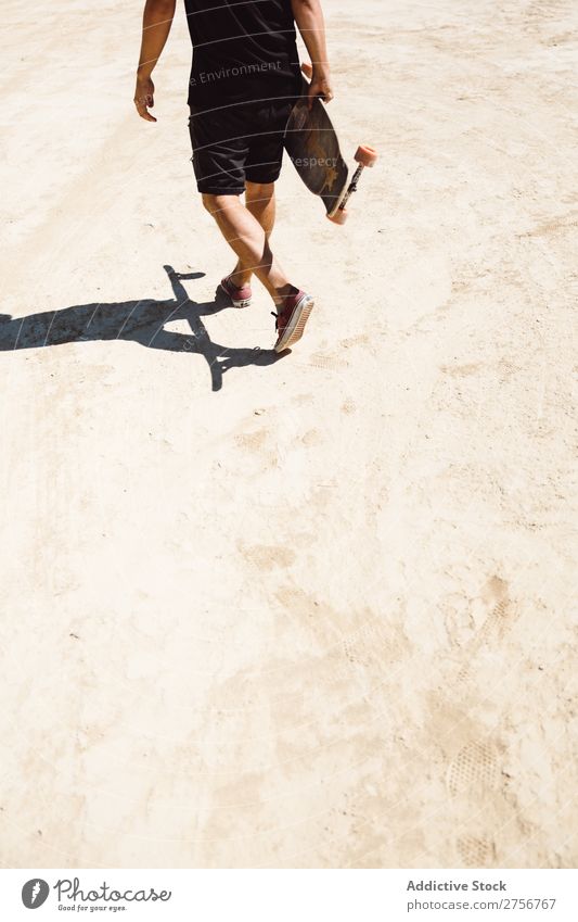 Crop man riding skateboard in desert Man Skateboard Desert Vacation & Travel Lifestyle Human being Adults Nature Adventure Trip Tourist Sports Action Extreme