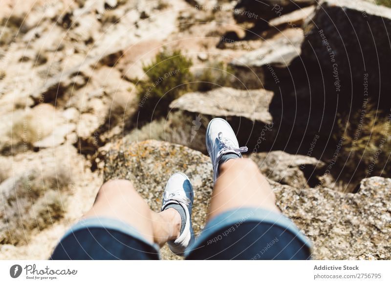 Man sitting on cliff Cliff hanging over Desert Vacation & Travel Legs Lifestyle Human being Adults Stone Rock Nature Adventure Freedom traveler Trip Tourist Hot