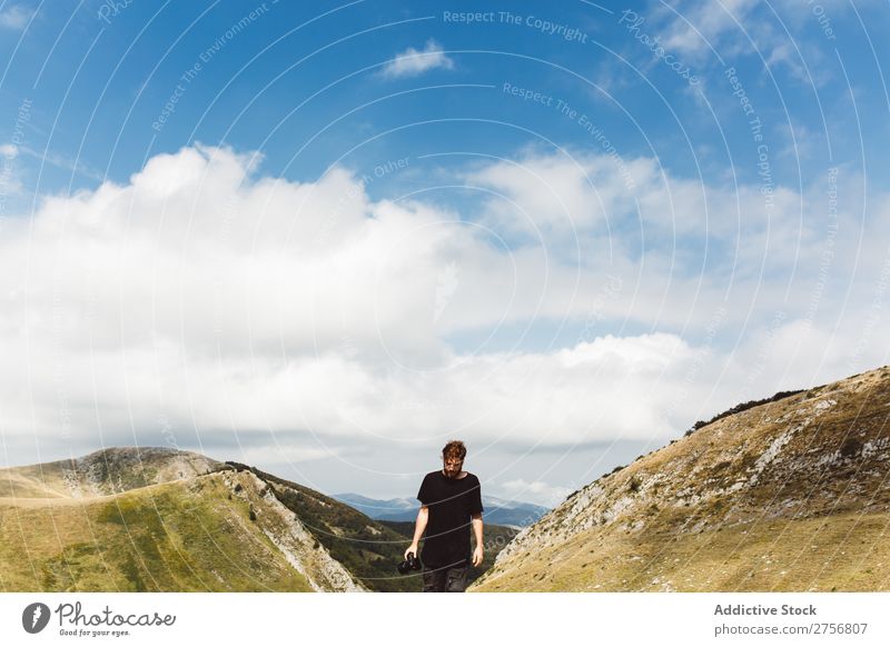 Tourist man hiking in hills Man Mountain Hill hiker trekking Human being Peak Nature Vacation & Travel Vantage point Picturesque Slagheap Landscape Height Rock