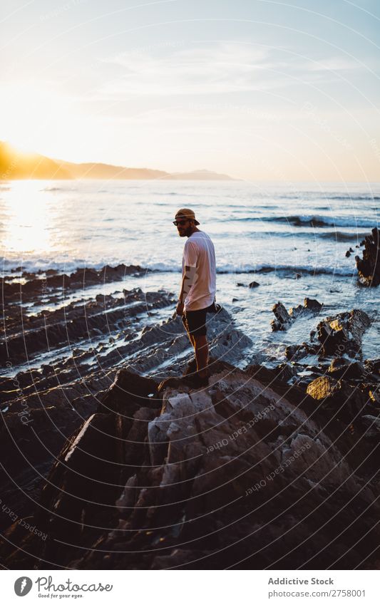 Man with camera on coastal rock Tourist Cliff Ocean Rock shots Camera Photographer Vacation & Travel Tourism Nature Landscape Coast Water Sun Freedom Stone