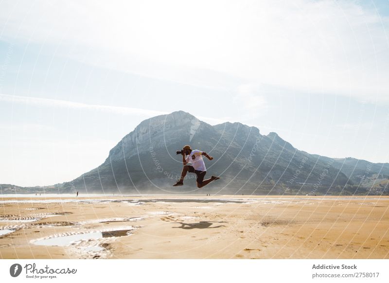 Man jumping on beach Hand Sand Beach Wet Summer Ocean Vacation & Travel Nature Human being Sunlight Leisure and hobbies Relaxation Tropical seaside Sunbeam