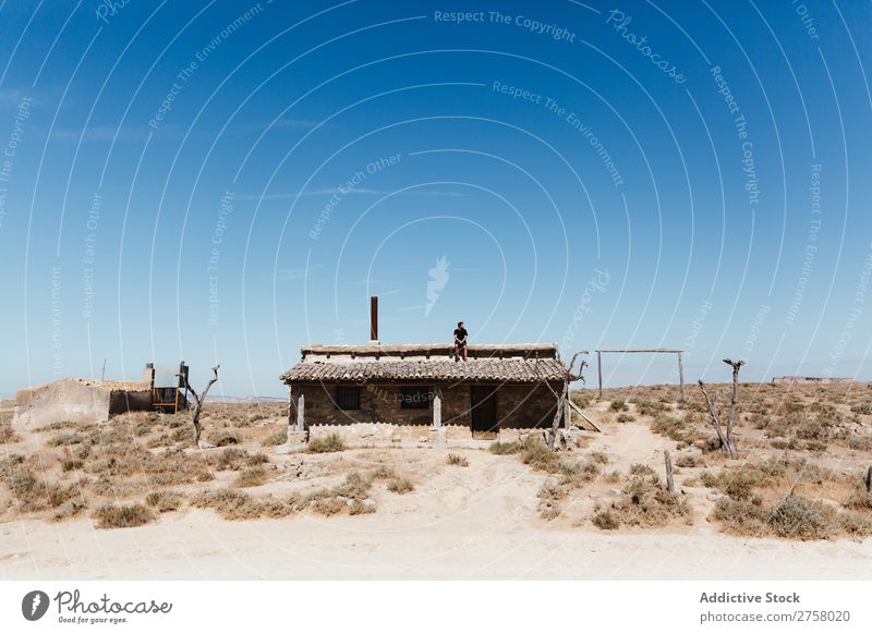 Man sitting on hut roof Hut Roof Desert Vacation & Travel Lifestyle Human being Adults Nature Adventure Trip Tourist Landscape House (Residential Structure)