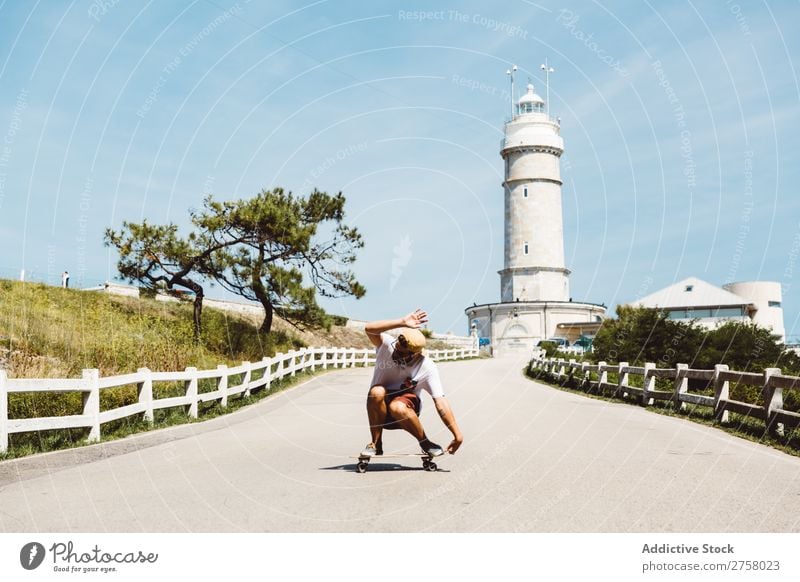 Man skateboarding at beacon skateboarder riding Asphalt Beacon Lighthouse seaside Sports Skateboard Lifestyle Ice-skating Skateboarding Ice-skates Extreme