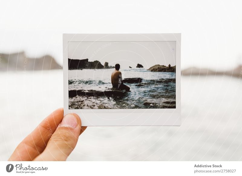 Hand with shot of man on shore Man Tourist Cliff Shot instant Ocean Rock Vacation & Travel Tourism Nature Landscape Coast Water Sun Freedom Stone Natural