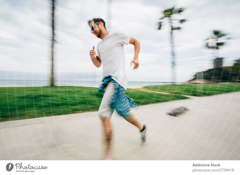 Man skating near sea Joy Running Blur Exterior shot Action Ride Athletic Ice-skates skaters handsome Youth (Young adults) Leisure and hobbies Skateboard Coast