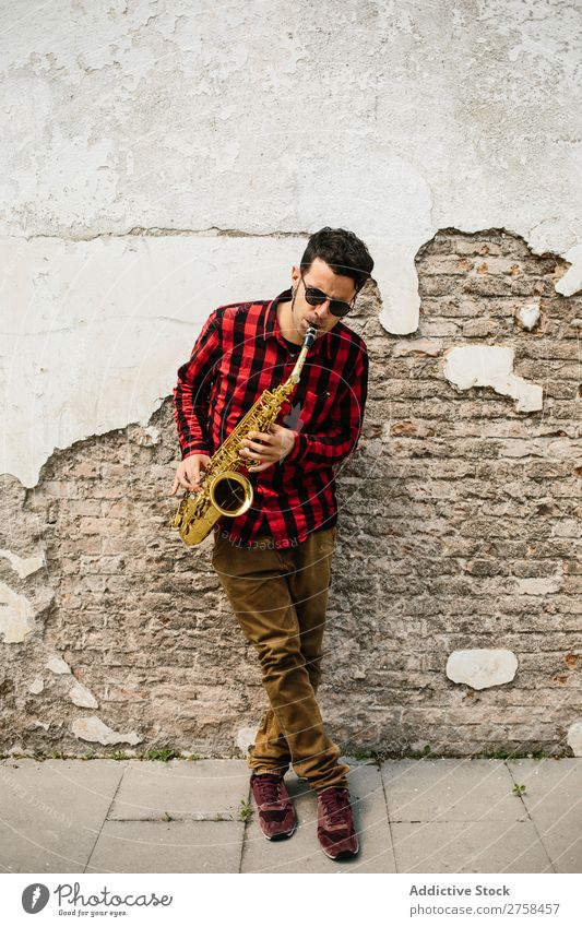 Smiling jazzman with sax Musician Man Sunglasses Self-confident Cool (slang) Cheerful Wall (building) Youth (Young adults) Jazz Saxophone instrument Musical