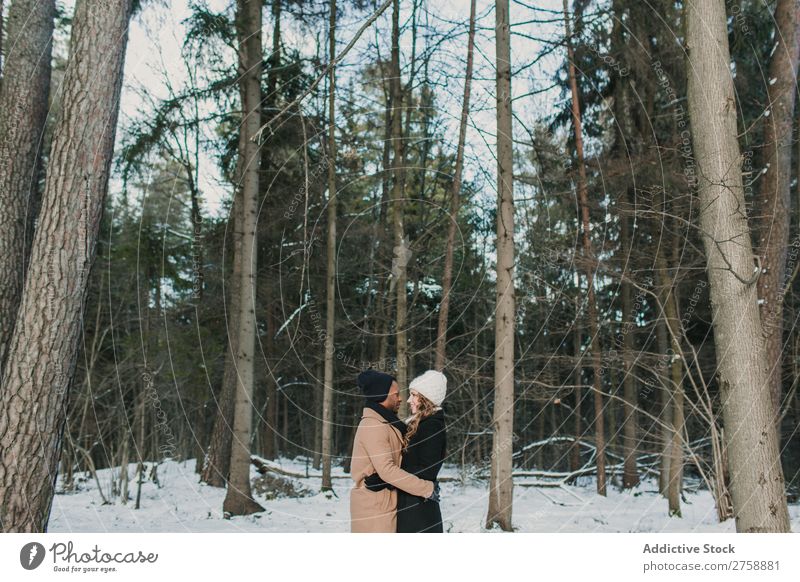 Couple posing in winter forest multiethnic Style warm clothes Easygoing Nature Forest Winter Snow piggyback Beautiful Mixed race ethnicity Black