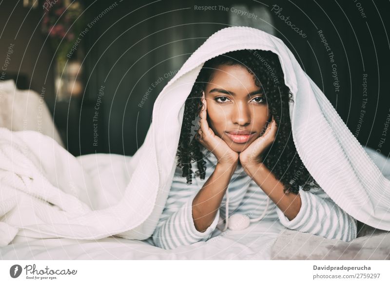 Beautiful serious thoughtful and sad black woman covering her head with sheet in bed Woman Bed Sadness Anger Black worried trouble problems Covered Covering