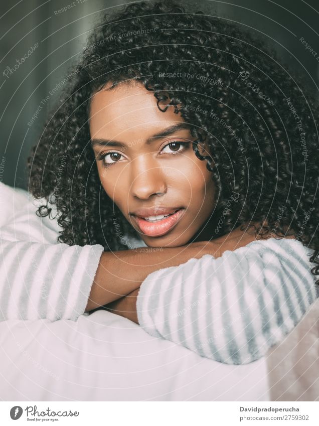 close up of a pretty black woman with curly hair smiling and lying on bed looking at the camera Woman Bed Portrait photograph Close-up Lie (Untruth) Black