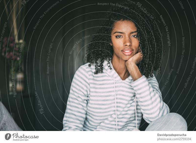 close up of a pretty black woman with curly hair smiling sit on bed looking at the camera Woman Bed Portrait photograph Close-up Sit Black Smiling African