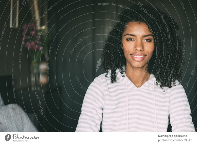 close up of a pretty black woman with curly hair smiling sit on bed looking at the camera Woman Bed Portrait photograph Close-up Sit Black Smiling African