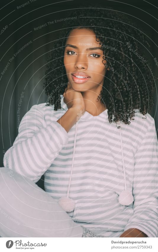 close up of a pretty black woman with curly hair smiling sit on bed looking at the camera Woman Bed Portrait photograph Close-up Sit Black Smiling African