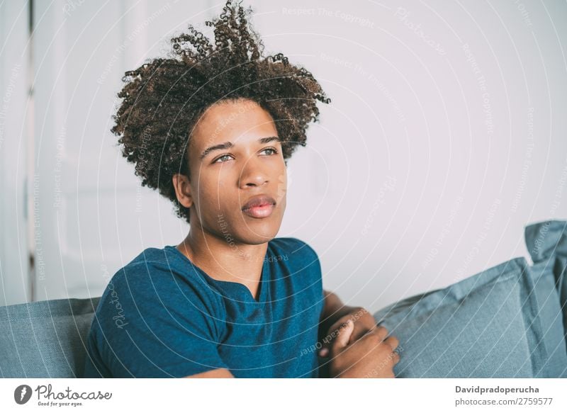 Portrait of a young thoughtful mixed race man sitting in the sofa Man Black Youth (Young adults) Portrait photograph Human being Mixed Racing sports American