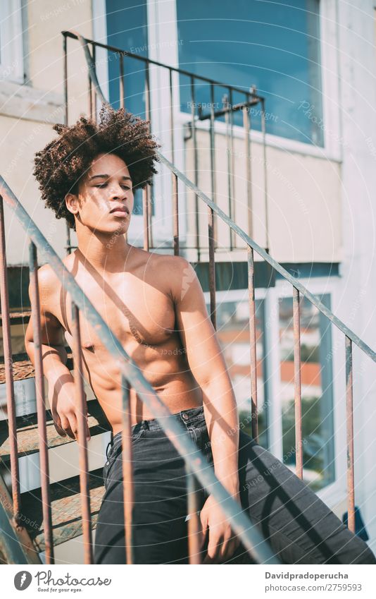 shirtless young black man sitting in the stairs Man Black Youth (Young adults) Athlete Naked Torso Human being Mixed race ethnicity Afro Curly hair Healthy Body