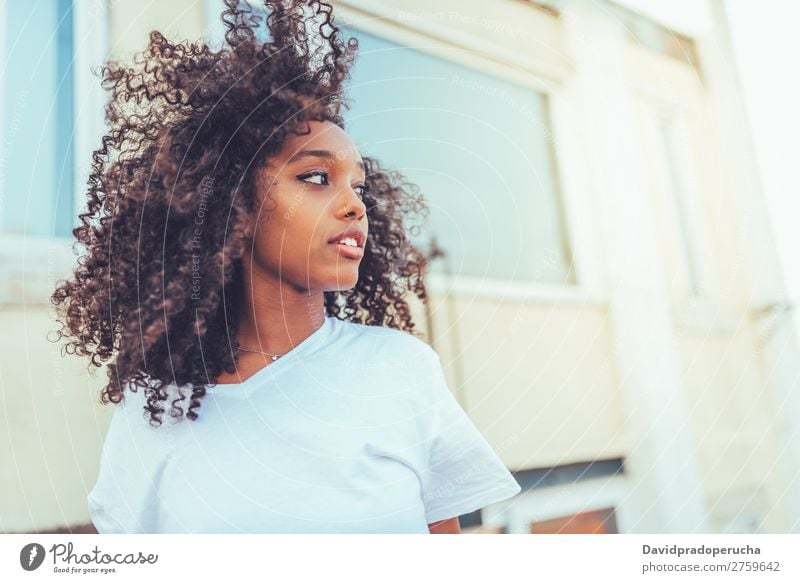 Young beautiful black woman on the stairs posing Woman Portrait photograph Smiling Mixed race ethnicity High heels Racing sports america Afro Curly Hair brunet