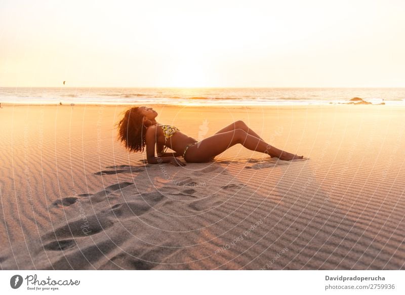 Beautiful young woman posing on the sand at the beach Beach Sand pose Woman Isolated romantic Ocean Sun Vacation & Travel Nature Swimming Suit Joy Gold Model