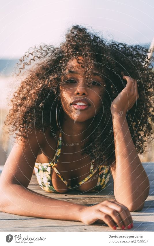 Beautiful young black woman lying down in a  wooden foot bridge at the beach Background picture Beach Bikini Black Bridge Coast Curly hair Destination Girl Cute