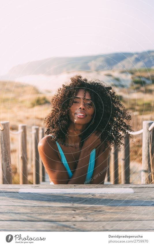 Beautiful young black woman lying down in a  wooden foot bridge at the beach Background picture Beach Bikini Black Bridge Coast Curly hair Destination Girl Cute