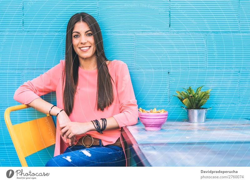 Happy young woman seating in a restaurant Adults Loneliness Attractive Beautiful Blue Bright brunet Caucasian Coffee Café Multicoloured enjoying Woman Food Girl