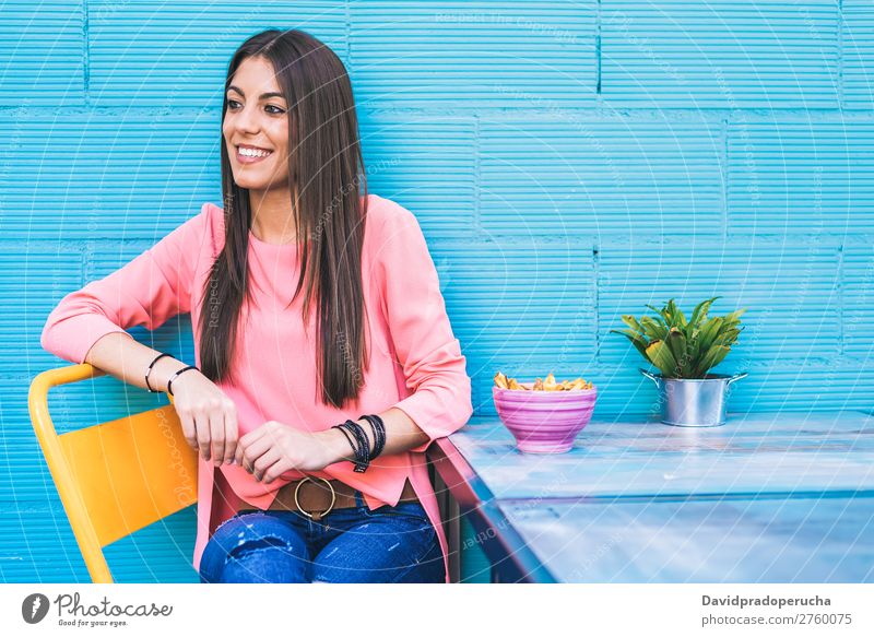 Happy young woman seating in a restaurant Adults Loneliness Attractive Beautiful Blue Bright brunet Caucasian Coffee Café Multicoloured enjoying Woman Food