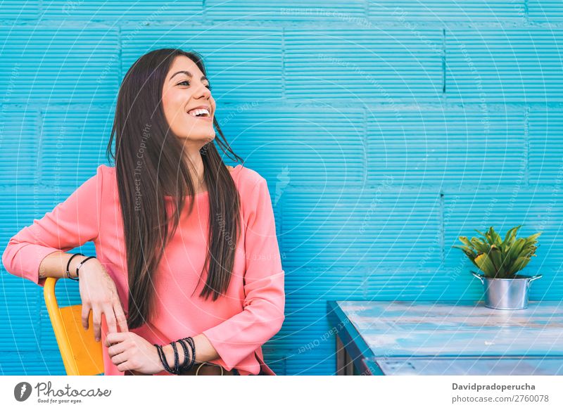 Happy young woman seating in a restaurant Adults Loneliness Attractive Beautiful Blue Bright brunet Caucasian Coffee Café Multicoloured enjoying Woman Food