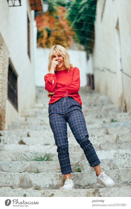 Happy young woman laughing on steps in the street. Lifestyle Style Beautiful Hair and hairstyles Human being Feminine Young woman Youth (Young adults) Woman