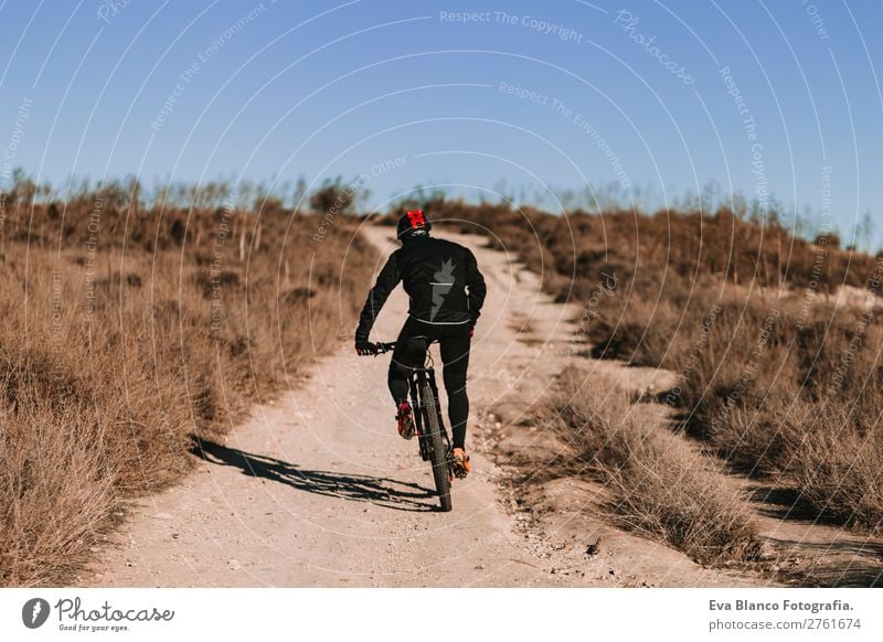 Cyclist Riding the Bike at Sunset. Sport Concept. Lifestyle Relaxation Leisure and hobbies Adventure Summer Mountain Sports Cycling Masculine Young man