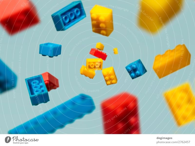 Floating Plastic geometric cubes in the air. Construction toys Design Playing Child Infancy Toys Brick Build Movement Blue Colour blocks falling background rows