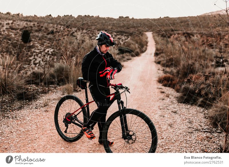 Cyclist Riding a bike at sunset. Sports Lifestyle Athletic Leisure and hobbies Adventure Summer Sun Mountain Cycling Masculine Young man Youth (Young adults)