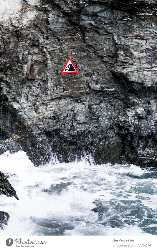 Caution: Rockfall Nature Plant Water Bad weather Wind Rain Waves Coast Aggression Threat Dark Power Warning sign Signage White crest Bleak Steep Colour photo