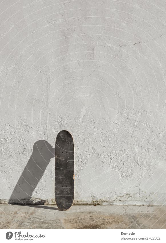 Skateboard on deteriorated white wall during a sunny day. Lifestyle Joy Athletic Wellness Harmonious Leisure and hobbies Adventure Freedom Summer