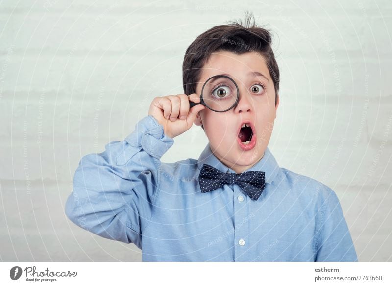 surprised child looking through magnifying glass on brick background Lifestyle Reading Science & Research Child School Human being Masculine Infancy 1